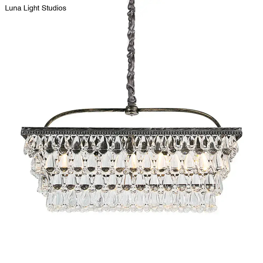 A multi-tiered modern silver ceiling light with teardrop crystal accents and a dark ornate metal frame 220v-240v
