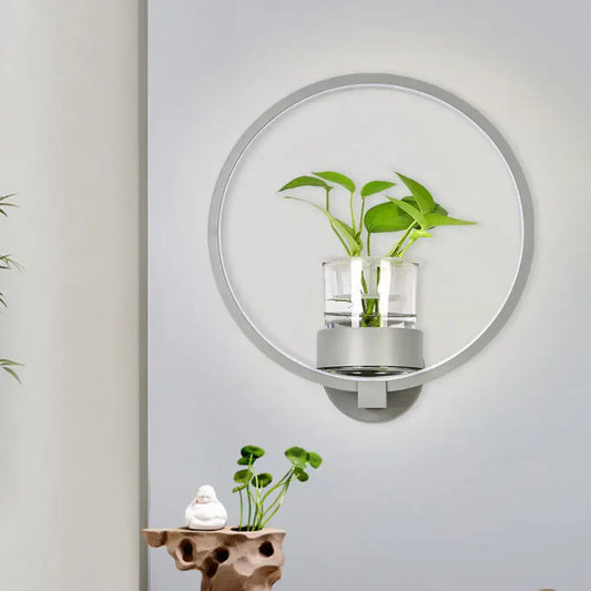 Modern silver circular wall light with plant pot featuring a clear glass cylinder and 110v-120v led sconce for bedroom