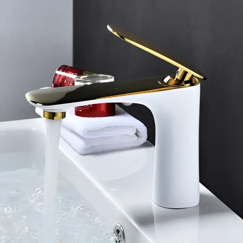 Modern single handle decorbites basin faucet in gold and white with a sleek curved spout for bathroom sinks