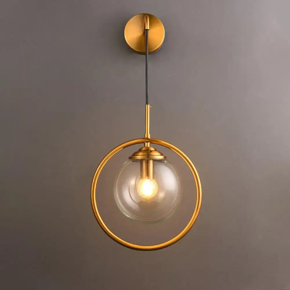 Gold-toned modern smoke gray clear glass globe sconce with circular frame and exposed bulb for bedroom wall light 220v-240v 110v-120v