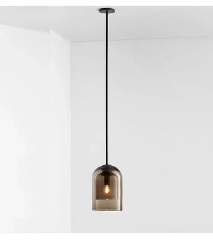 A sleek black modern smoked glass led chandelier with an exposed bulb for dining room lighting