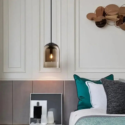 A sleek modern smoked glass led chandelier with black cord hanging above the bed for dining room lighting
