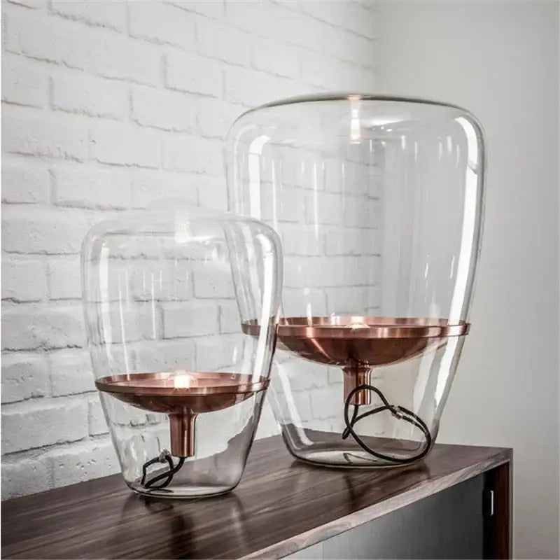Modern smoked glass table lamp with clear glass lanterns and copper bases designed as a glass table lamp