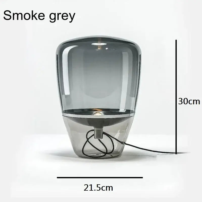 Modern smoked glass table lamp with smoke grey balloons glass table shade and sleek metallic base for bedroom use