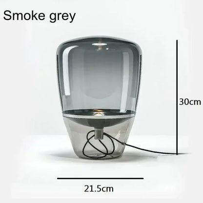 Modern smoked glass table lamp with smoke grey balloons glass table shade and sleek metallic base for bedroom use