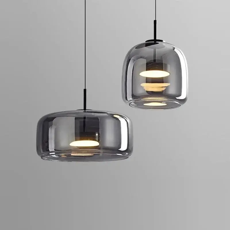Modern smoked gray glass led pendant chandelier with warm circular bulbs and sleek black cords for dining room lighting