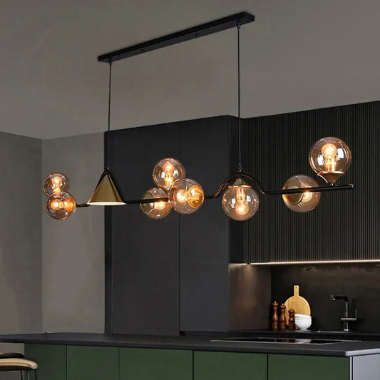 Modern black metal pendant light with smoky grey glass globes and gold-toned triangular accent for dining room