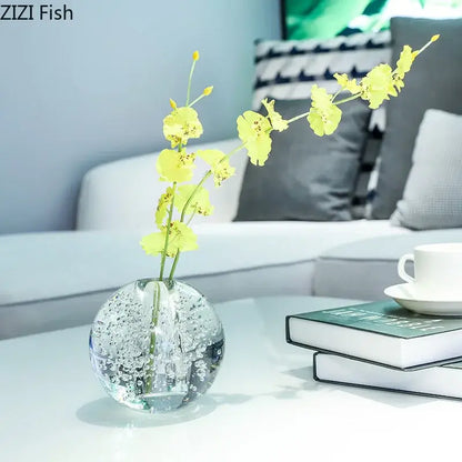 Modern spherical clear glass vase with bubbles holding bright yellow orchid flowers for decorbites clear glass decor