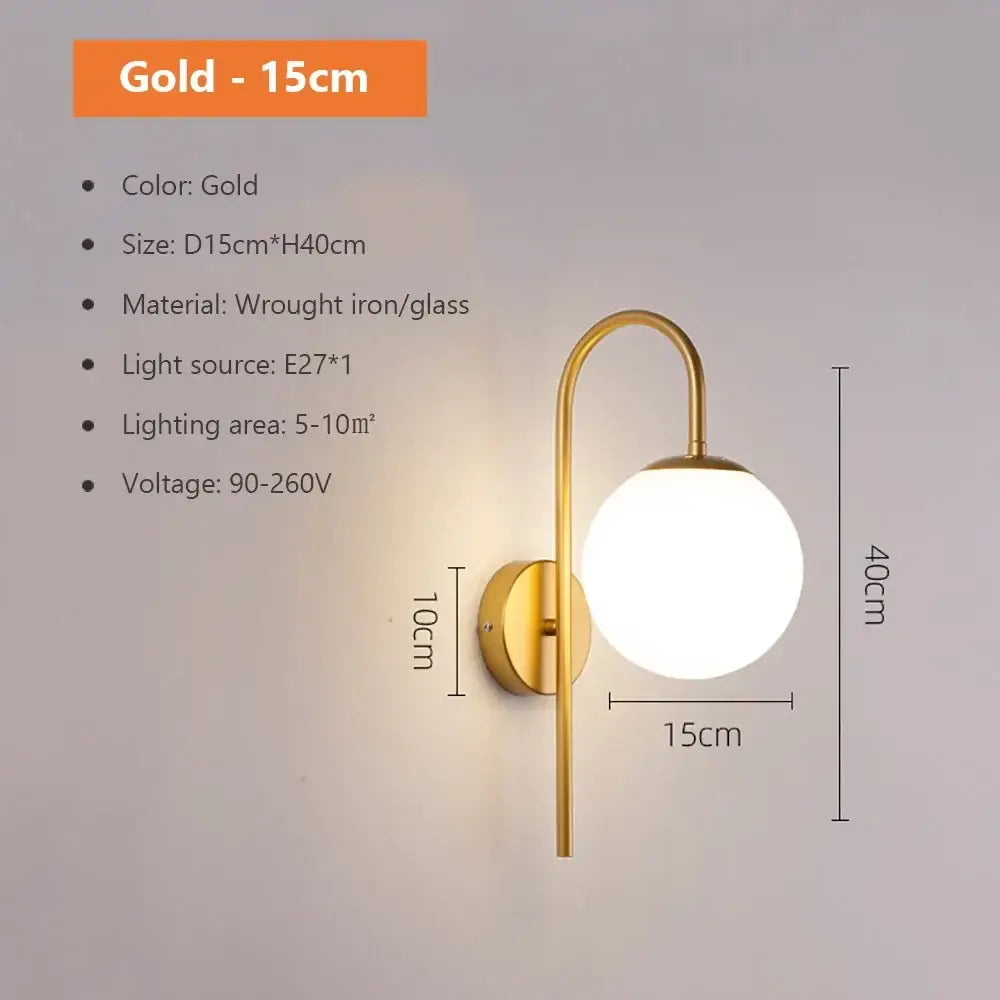 Modern spherical glass shade gold wall lamp with curved wrought iron arm and round glass globe for bedroom use