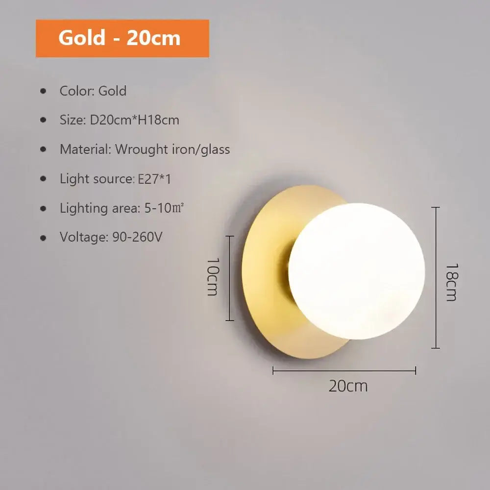 Modern spherical glass shade gold wall lamp with circular globe and wrought iron base for bedroom lighting