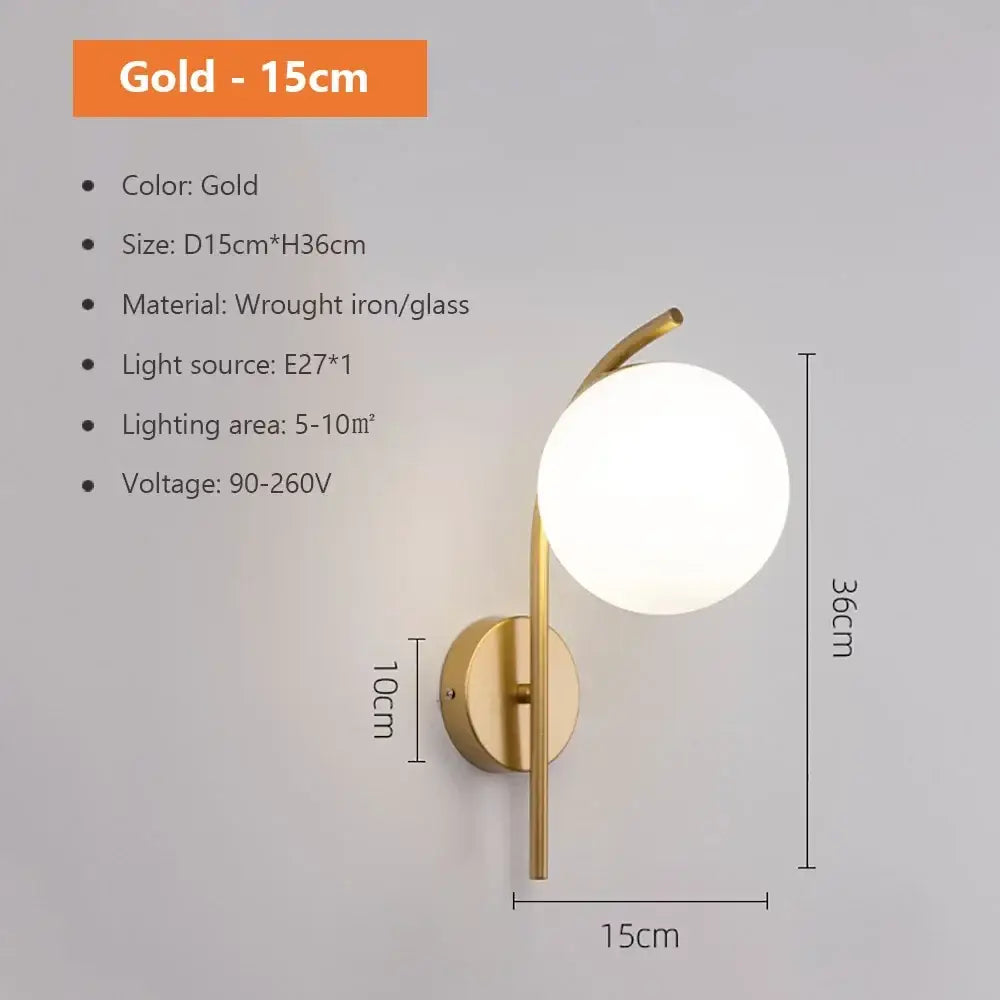 Modern spherical glass shade gold wall lamp with a sleek wrought iron frame and frosted globe for bedroom use