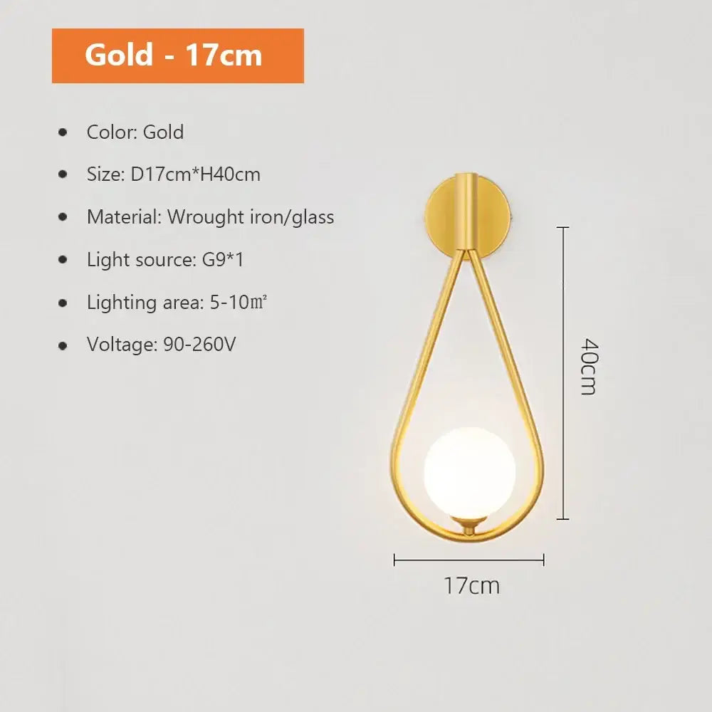 Modern spherical glass shade gold wall lamp featuring a teardrop wrought iron frame with integrated g9 bulb