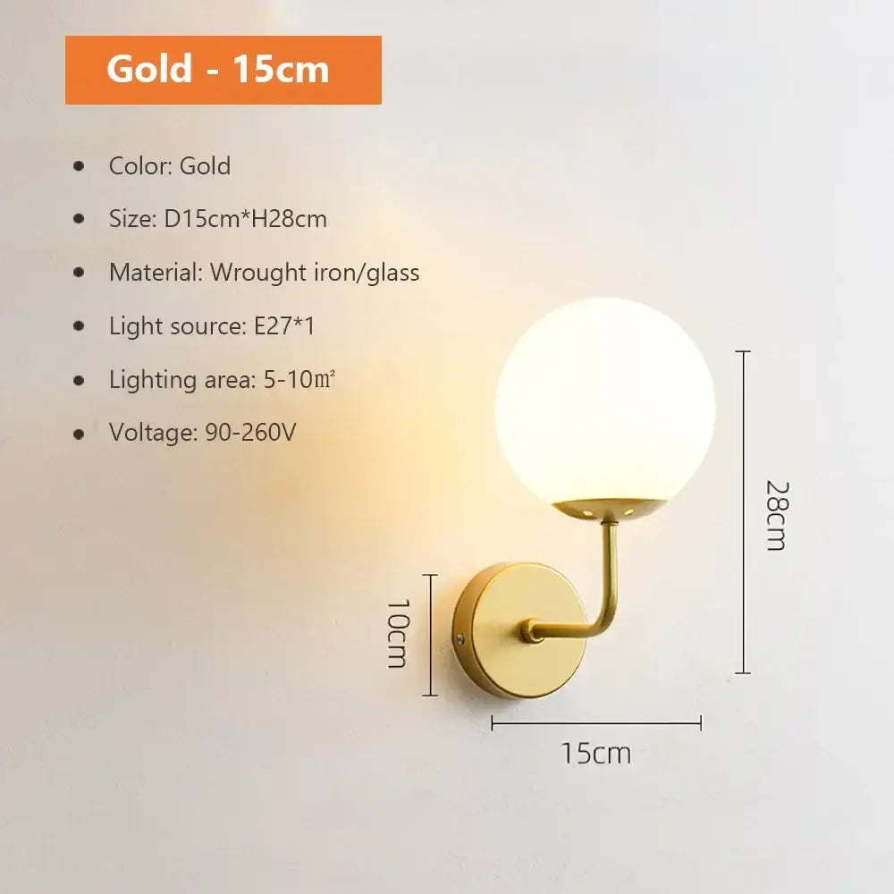 Modern spherical glass shade gold wall lamp with spherical glass globe and wrought iron arm for bedroom use