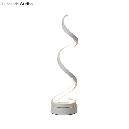 A modern spiral black white gold led table lamp with a minimalist curved design for bedroom task light