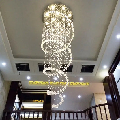 Modern spiral crystal led ceiling chandelier with cascading clear faceted beads emitting warm light by decorbites crystal led