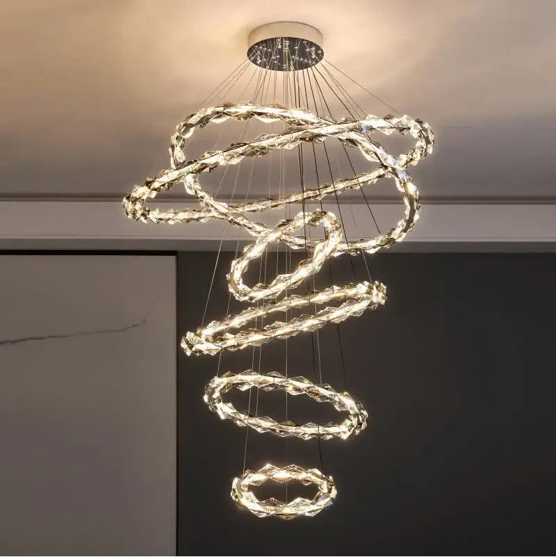A modern spiral decorbites crystal chandelier with glowing LED rings and a sleek metallic ceiling mount for living rooms