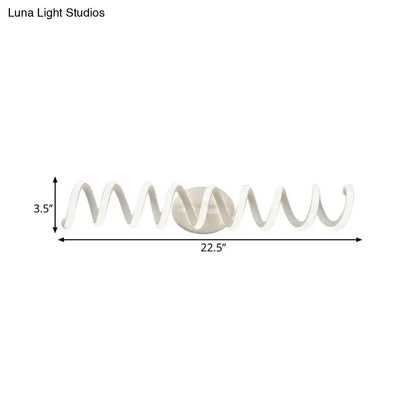 Modern white spiral wall light with sleek curved design and metallic center offering natural warm led illumination