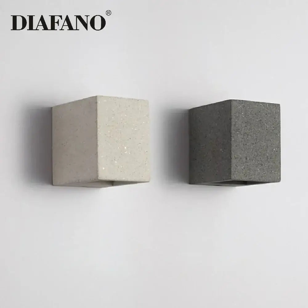 Two minimalist cement wall lamps in light beige and dark gray with textured surface for modern kitchen decorbites cement wall lamp
