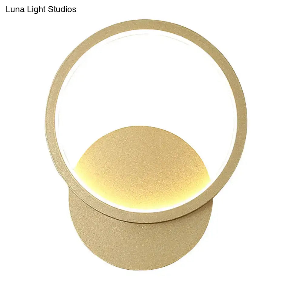 Modern gold-toned circular wall sconce lighting with minimalist concentric rings for living room wall sconce use