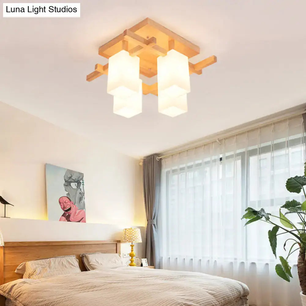 Modern wooden ceiling light fixture with four frosted white glass shades and a minimalist geometric frame design