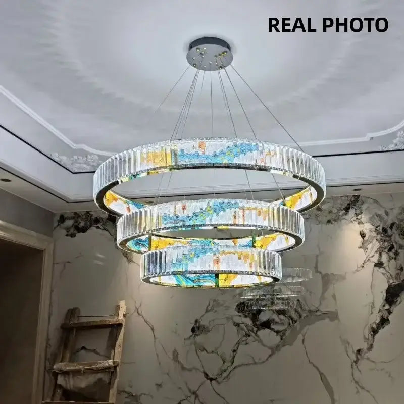 Modern stained glass circle steel led pendant chandelier with cascading crystal rings in vibrant blue yellow and white decorbites circle steel design