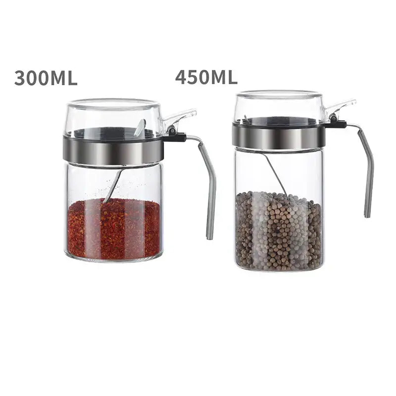 Modern stainless steel and glass seasoning pot set with clear glass seasoning containing red pepper flakes and black peppercorns for kitchen supplies