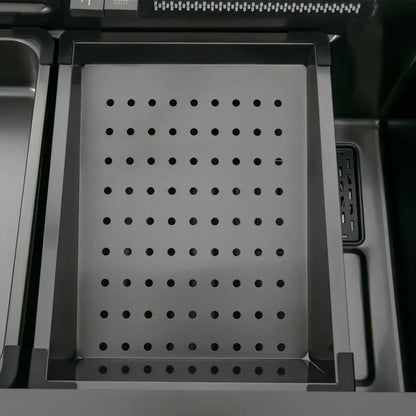 Modern stainless steel waterfall kitchen sink accessory with a rectangular tray featuring evenly spaced circular holes