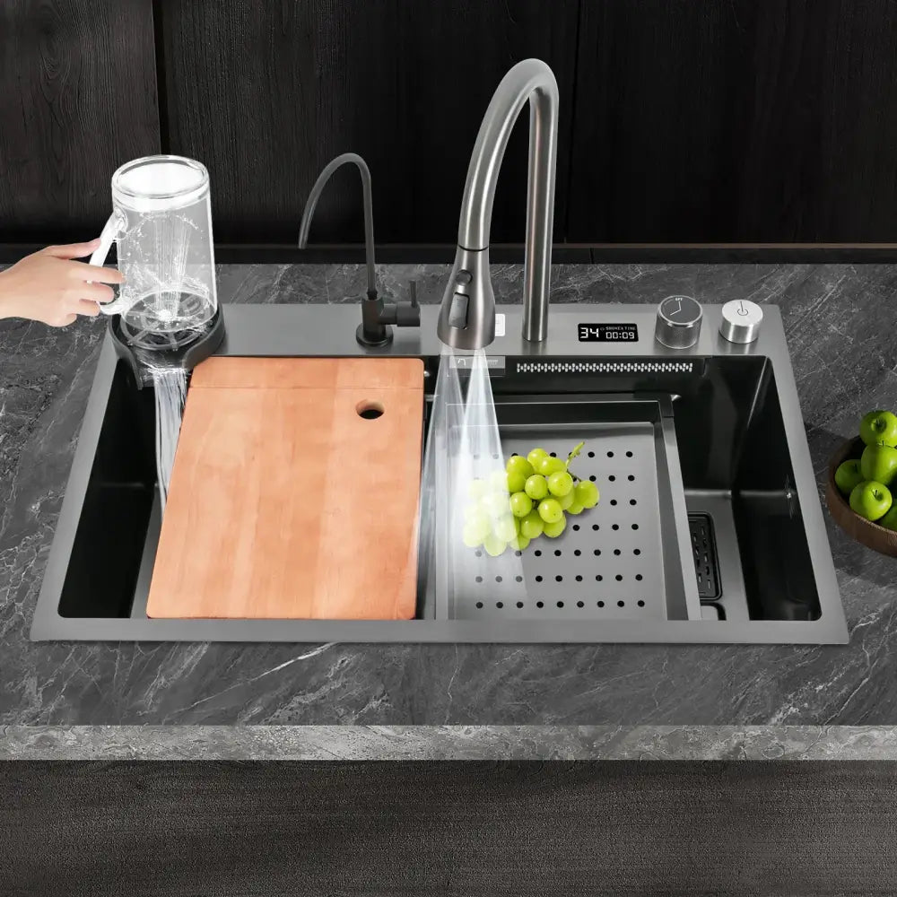 Modern stainless steel waterfall kitchen sink with sleek curved pull out faucet and integrated digital display