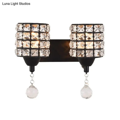 Modern style black wall sconce with two crystal shade cylinders and dangling teardrop crystals 110v-120v light fixture