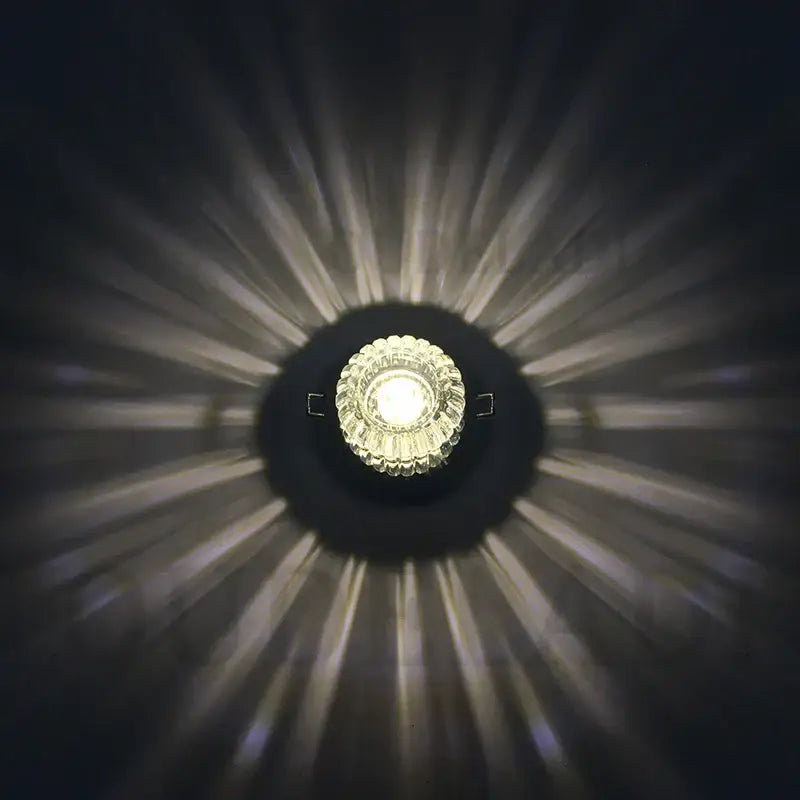 A modern sunburst decorbites crystal led flush mount ceiling light with faceted crystal center emits warm white illumination