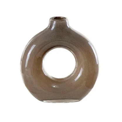 A sleek matte taupe ceramic vase with a modern donut shape and narrow neck for decorbites geometric circles decor