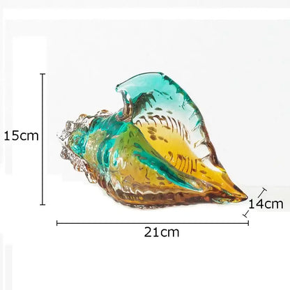 A vibrant translucent teal and amber glass conch shell statue for modern living room decor