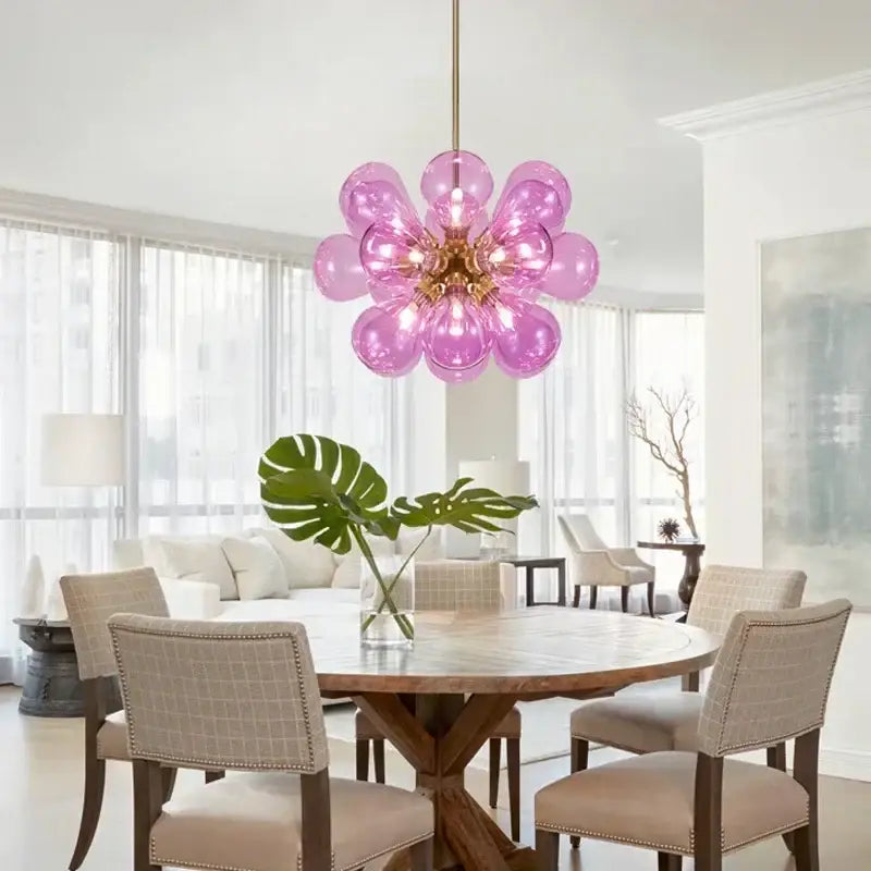 A vibrant pink glass bubble hanging pendant light with gold-toned fixture for modern dining room decorbites glass bubble