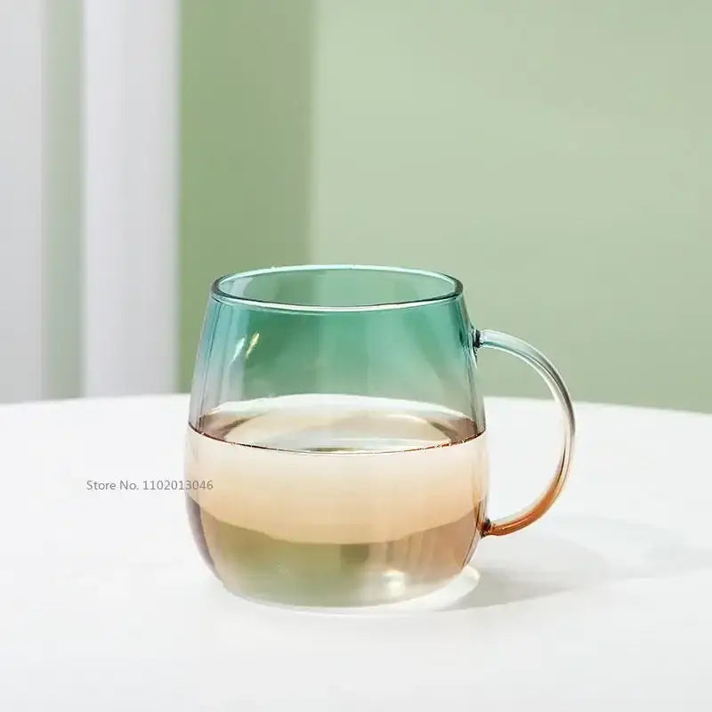 Modern teal and gold glass teapot set featuring a gradient glass mug with teal to amber color and clear curved handle