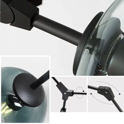 Black metal arm with matte finish connects to a translucent teal glass globe in modern decorbites glass branch ceiling chandelier