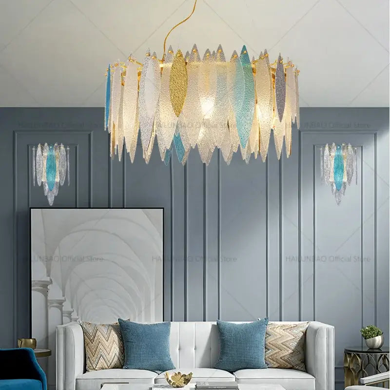 Modern teal and gold glass chandelier light with cascading translucent glass leaf shades for living room use