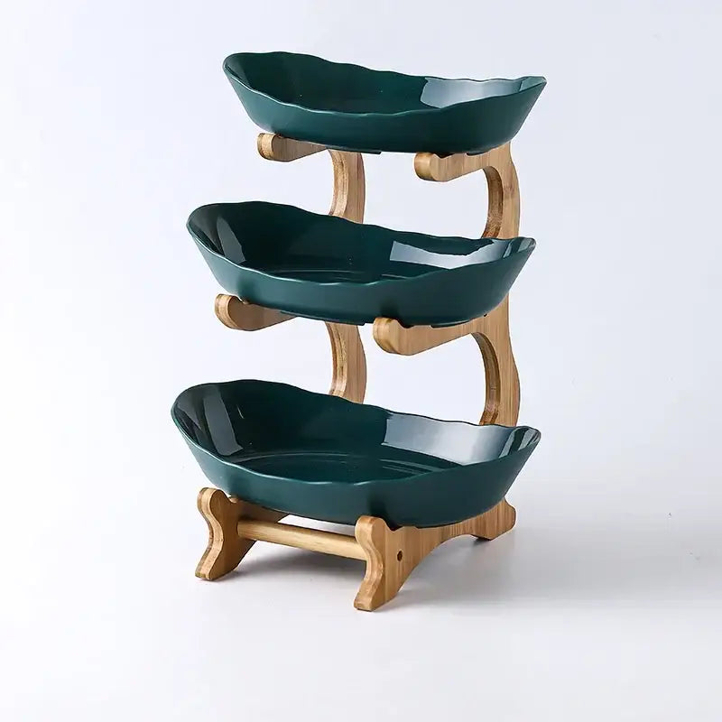 Modern teal and white ceramic three-tiered layer table plates with leaf-shaped bowls and bamboo supports for dining room