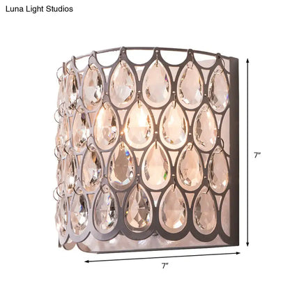 Modern teardrop crystal wall mounted light with dark metal frame and clear crystals for bedroom white sconce