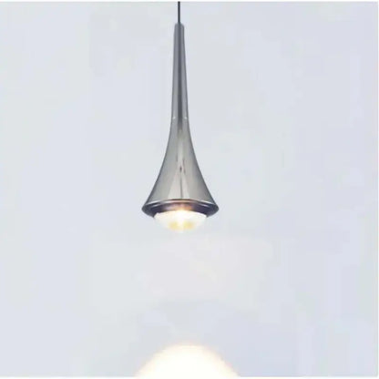 A sleek modern pendant light with metallic gold finish and black and white cord pendant for dining room use