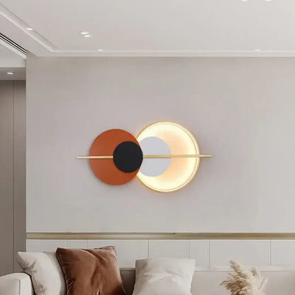 Modern terracotta and black decorbites circular wall lamp with overlapping discs on gold bar luxury wall lamp for bedroom