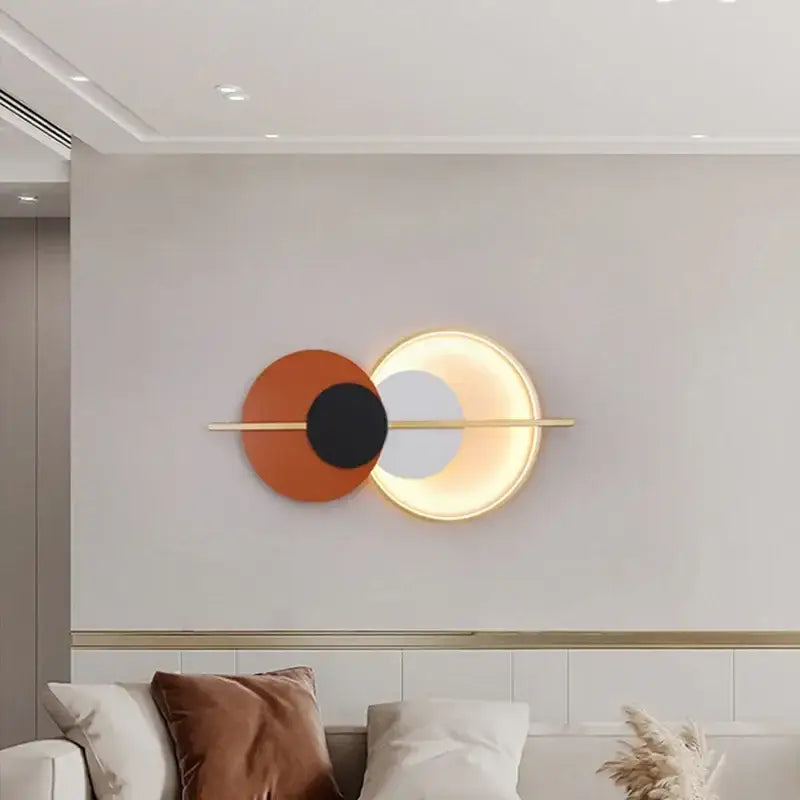 Modern terracotta and black decorbites circular wall lamp with overlapping discs on gold bar luxury wall lamp for bedroom
