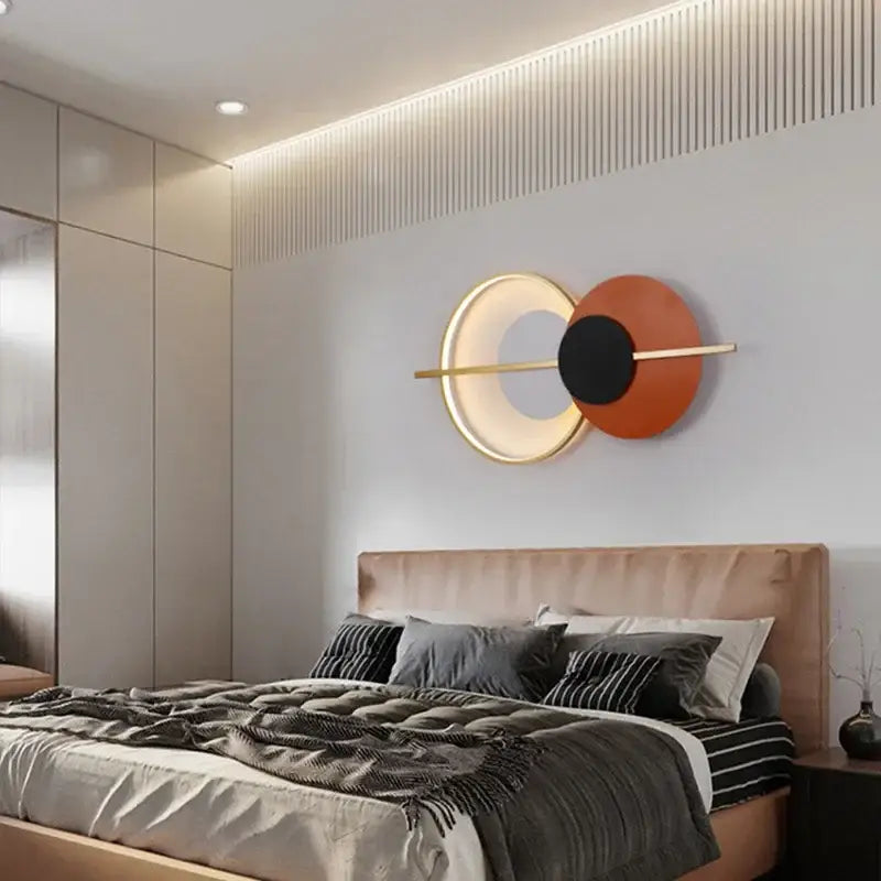 Modern terracotta and black decorbites circular wall lamp with glowing gold ring and sleek horizontal bar for bedroom use