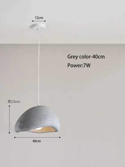 A modern grey pendant light with a textured dome shade and white cord for decorbites cream cloud chandelier decor