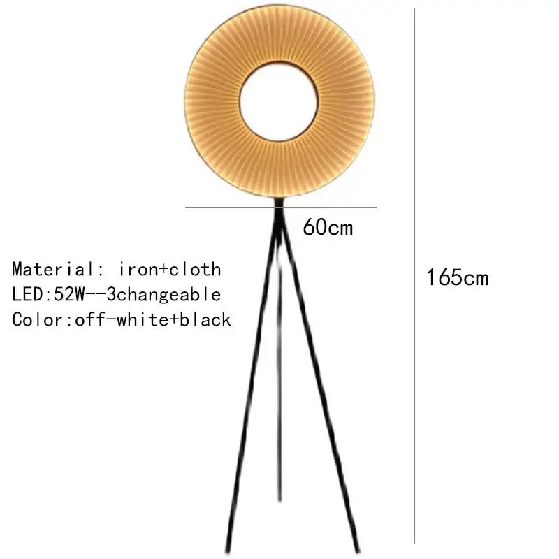 A modern floor lamp with dix heures round fabric pleated off-white shade and black iron legs for dining room lighting
