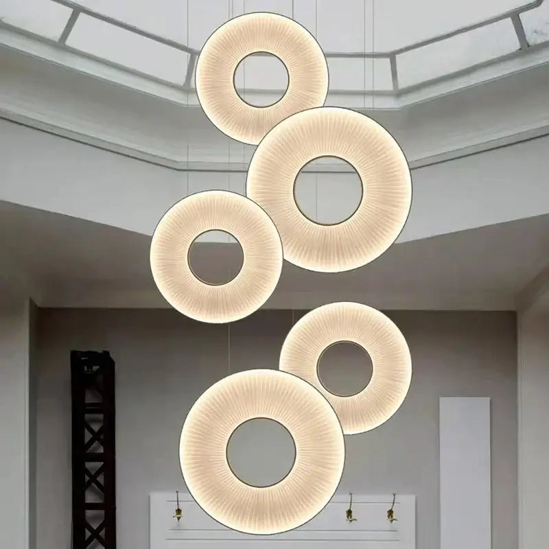 Modern textured dix heures round fabric led pendant light with warm glowing illumination and ribbed surface for dining room
