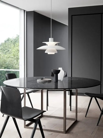 White layered metal hanging light with modern tiered design above dining table decorbites danish designer suspension lamp