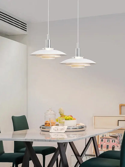 Two minimalist white hanging light pendant lamps with sleek silver metal fixtures by decorbites danish designer