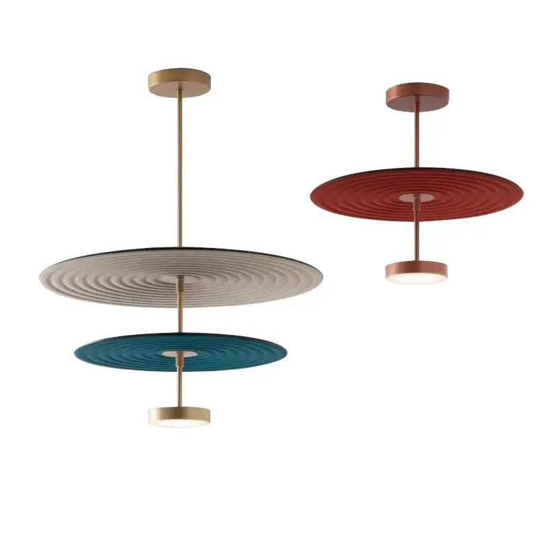 Modern tiered pendant lights with concentric cotton round led patterns in beige teal and terracotta on brass frames