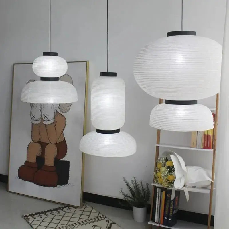 Three white ribbed paper pendant lights with black metal tops for dining room decorbites designer led modern tiered style