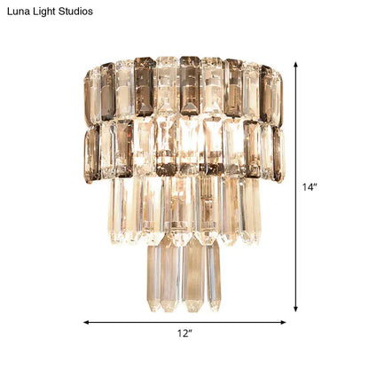 Modern tiered smoke gray crystal wall sconce with cascading smoked and clear crystal prisms for living room decor